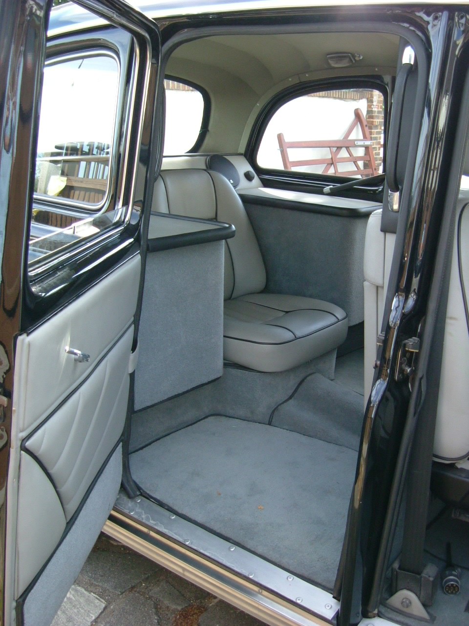 The rear passenger seat (now a single due to the wheel tubs but it still has the two pull down taxi seats as well